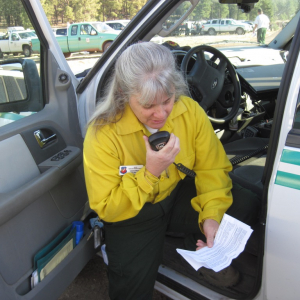 Valerie Meyers is a NOAA incident meteorologist on the scene of wildfires in Luna Lake, Ariz. Here she is conducting a radio weather briefing with crews at a remote location in the fire area.
