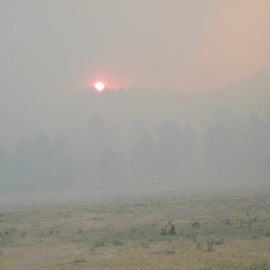 A smoky sunset west of an incident command post near Eager, Ariz.
