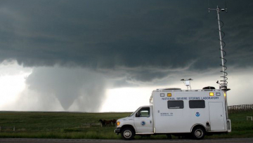 The field command vehicle operated by NOAA's National Severe Storms Laboratory coordinates research activities surrounding a tornado during the recent VORTEX2 study.
