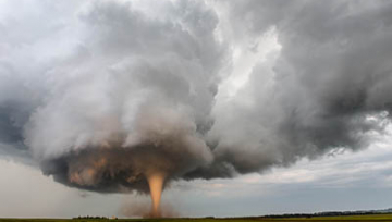 A tornado churns up dust in the sunset near Traer, Iowa. 