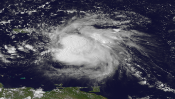 Tropical Storm Erika tracks over the Lesser Antilles, as seen by the GOES East satellite at 1915Z on August 27, 2015.