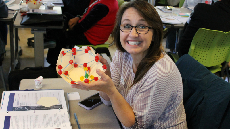 An enthusiastic educator builds a methane hydrate model as part of a lesson focused on ocean energy during a NOAA Office of Exploration and Research Exploring the Deep Ocean with NOAA professional development workshop. The workshop took place at the Aquarium of the Pacific in San Diego, California.