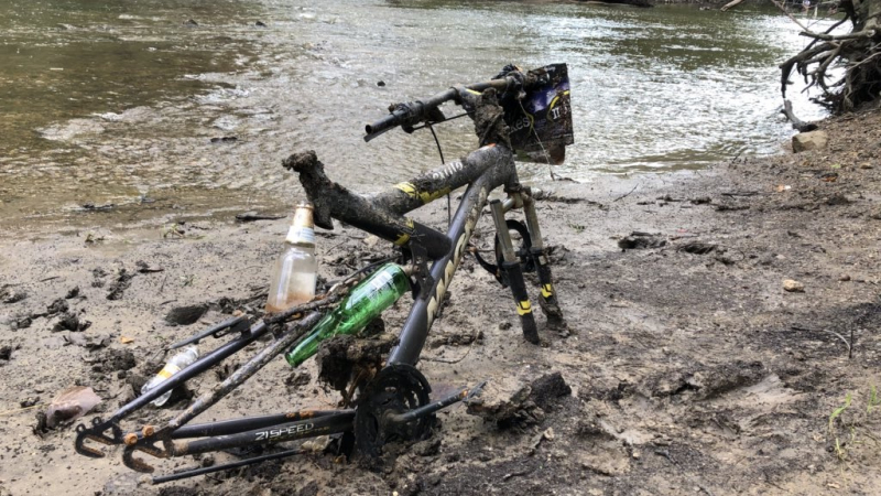You can find a lot of interesting types of trash tangled in branches or stuck in mud! Most commonly found are plastic bags or food wrappers, but you can also find larger items, like this bike, stuck in the mud.
