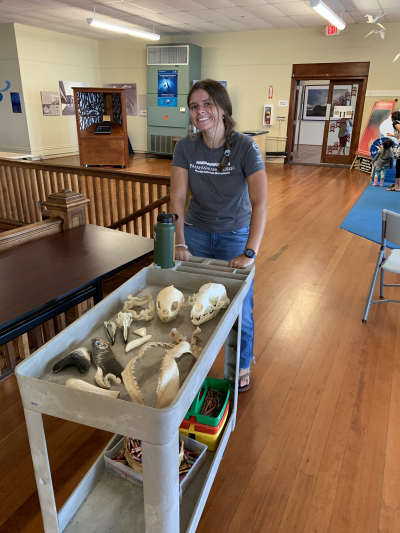 Carina Burroughs, a 2018 NOAA Hollings scholar, transports animal skulls and jaws on a cart for a lesson on predator anatomy at Mokupāpapa.