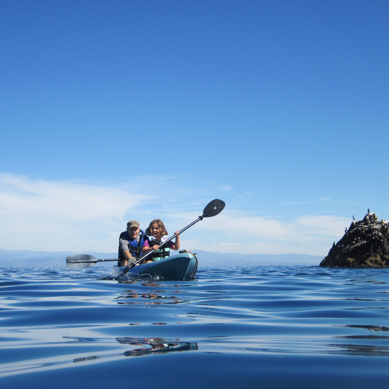 A father and daughter enjoy a kayak trip in NOAA's Channel Islands National Marine Sanctuary. Be sure to check the weather forecast before venturing out on the water, wherever you might be.