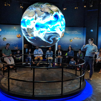 Meteorologist/Climatologist Tom DiLiberto presents on NOAA Science On a Sphere during NOAA Kids Day 2019.