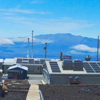 NOAA's Mauna Loa observatory is a premier research facility that has continuously monitored and collected atmospheric data since the 1950s. This photo, taken in 2019, shows the observatory on its perch at 11,000 feet elevation on Hawaii's tallest mountain, which enables sampling of "background" air that is free of local pollution. 