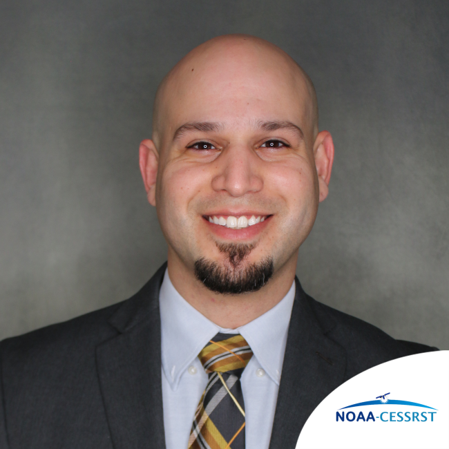 A professional headshot of Julio in a suit. The corner of the photo has a logo that reads "NOAA-CESSRST"
