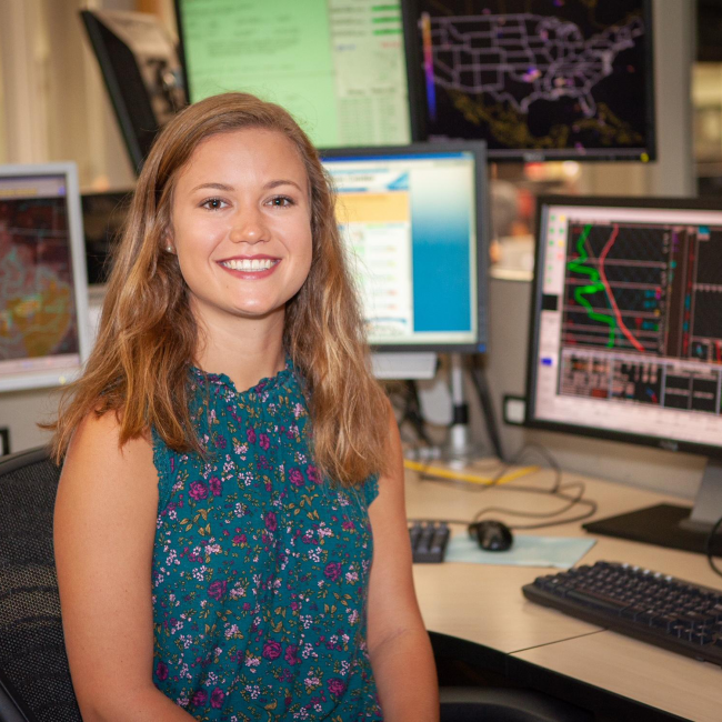 Hollings scholar Caitlin Ford is analyzing Short Range Ensemble Forecast Dry Thunderstorm Probabilistic Model Guidance during her internship with the National Weather Service at the National Weather Center in Norman, Oklahoma. In addition to her research project, Caitlin is shadowing forecasters at the NWS Storm Prediction Center (where this photo was taken) and the Norman Weather Forecast Office this summer to learn more about potential career paths in meteorology.