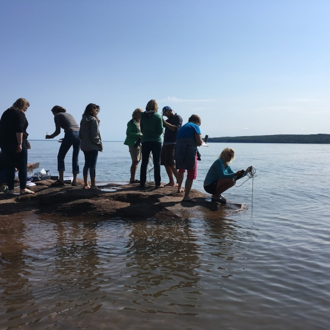 Teachers collect water quality data from the shoreline of Lake Superior during the Rivers2Lake Summer Institute.