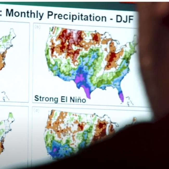 NOAA physical scientist Anthony Arguez reviews El Niño and La Niña winter precipitation Climate Normals on a computer screen at NOAA's National Centers for Environmental Information.