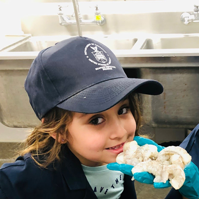 Kids visiting NOAA’s seafood inspection lab in Long Beach, California, learn how to inspect shrimp for quality, freshness and safety.