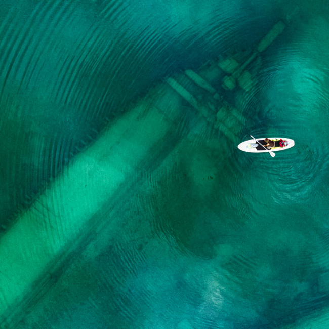 A person kayaks over a shipwreck within Thunder Bay National Marine Sanctuary